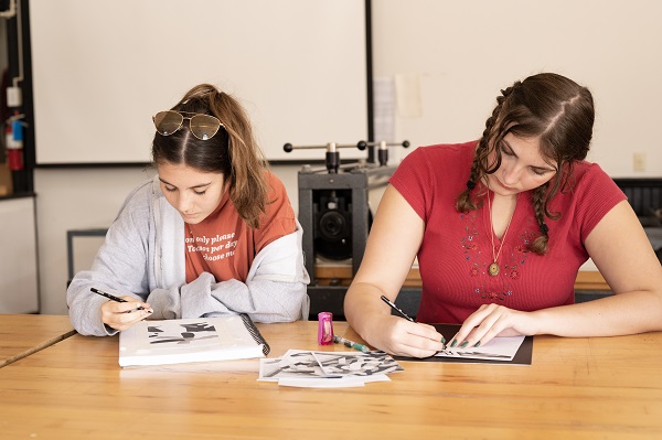 Studio Art Students Drawing in Sketchbooks