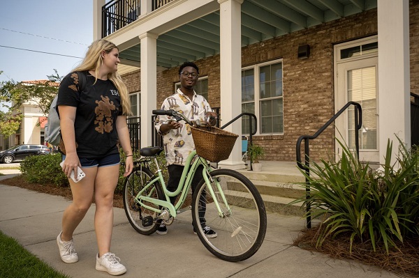 Students with Bicycle in Front of Porch