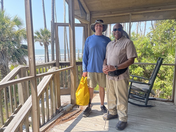 Chancellor and Researcher in Beach Cabin on Pritchards Island