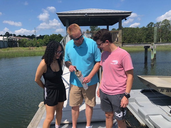 Students with teacher on dock